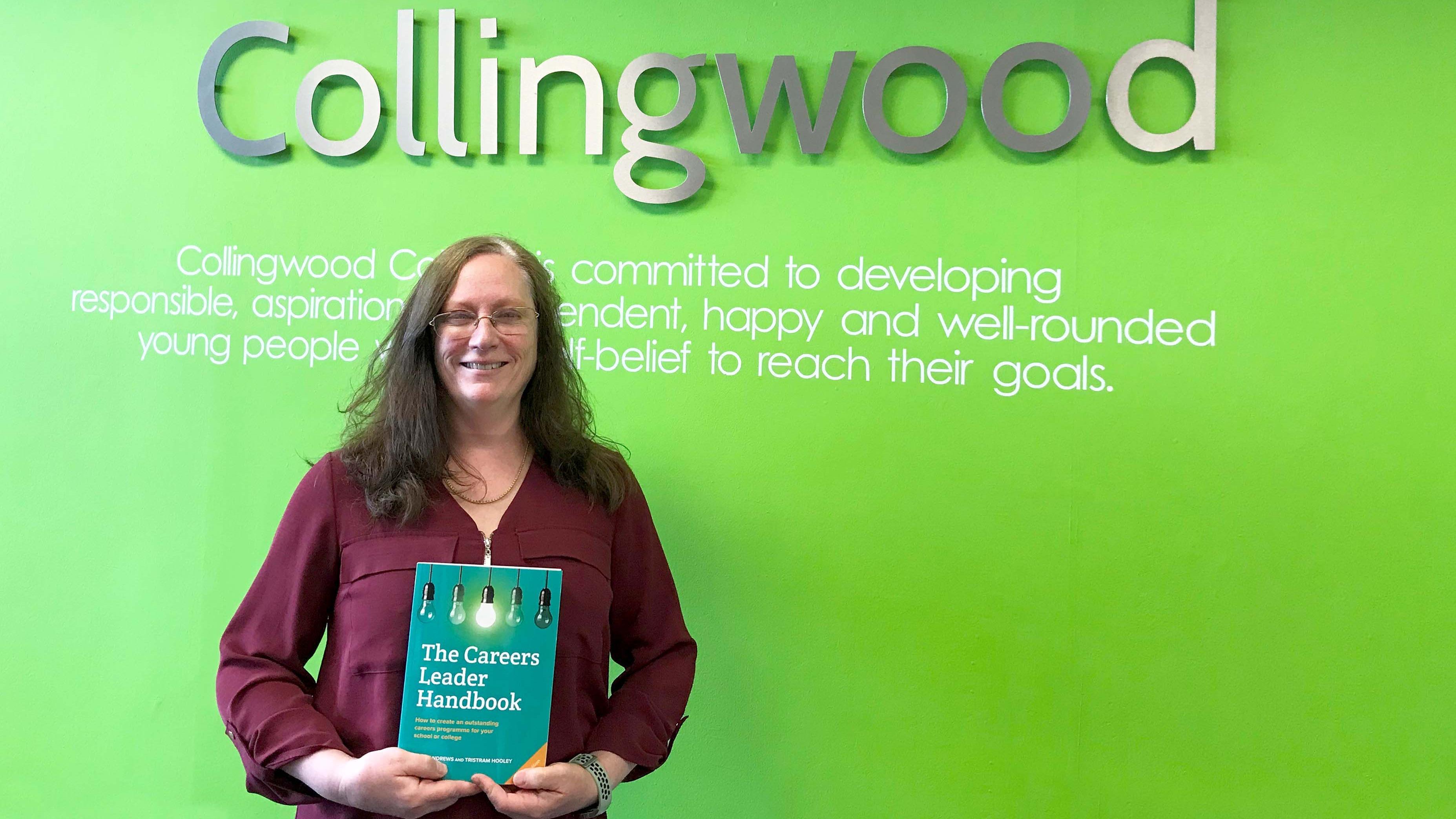Emma Clelland, from Collingwood College, with a copy of The Careers Leader Handbook